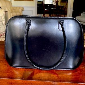 Stylish computer bag. Holds a IMac easily with papers over the shoulder straps